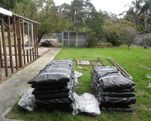 Photo looking at CCS supplies in back yard of work site