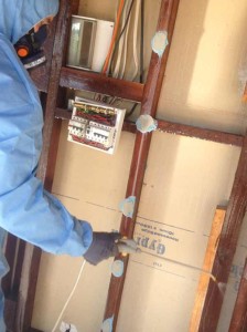 Photo of CCS worker spraying a mixture of PVC glue and water to seal in any particles